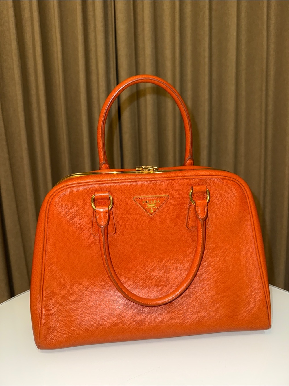Prada Orange Saffiano pyramid with Gold Hardware